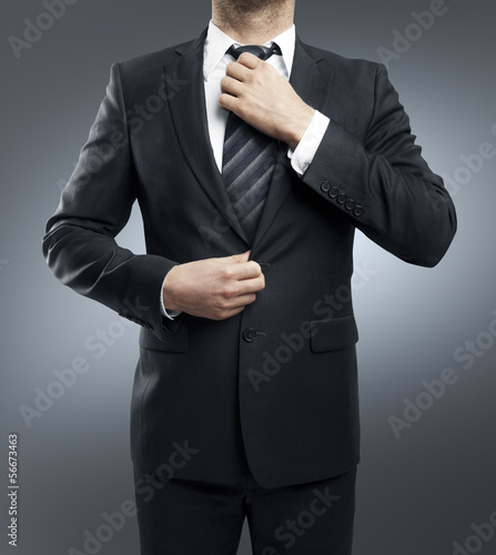 Photo: man adjusts tie man adjusts tie