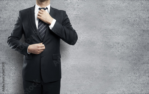 Photo: man adjusts tie man adjusts tie