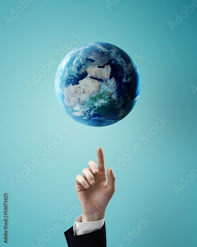 Photo: hand pointing at earth hand pointing at earth