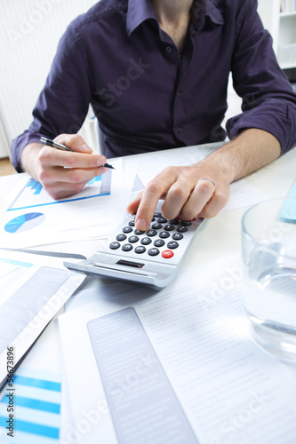 Photo: business man analyzing financial data business man analyzing financial data