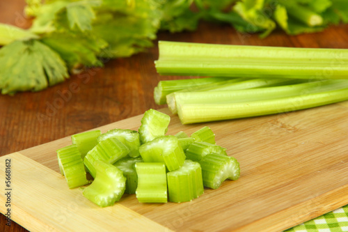 Photo: Fresh green celery on table close-up Fresh green celery on table close-up