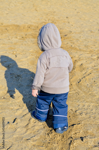 Photo: Young boy walking on the beach Young boy walking on the beach