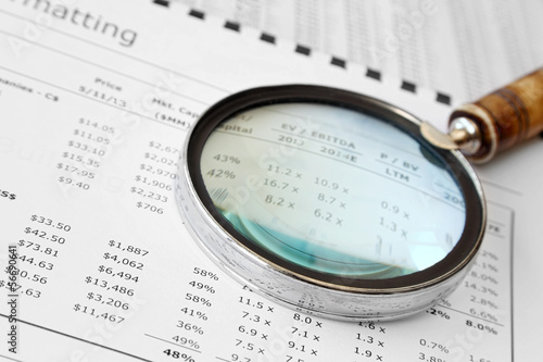 Photo: Magnifying Glass Over Financial Document Magnifying Glass Over Financial Document