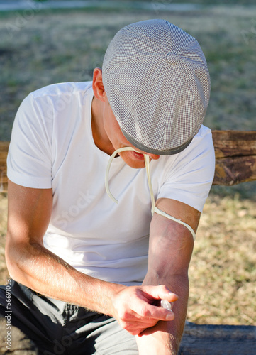 Photo: Addicted man injecting his tied arm intravenously Addicted man injecting his tied arm intravenously