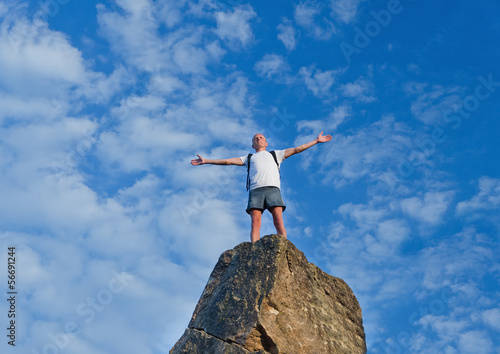 Photo: Man celebrating reaching the top of a mountain Man celebrating reaching the top of a mountain