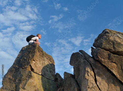 Photo: Backpacker on a distant rocky mountain peak Backpacker on a distant rocky mountain peak