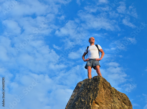 Photo: Determined man standing on mountain top Determined man standing on mountain top