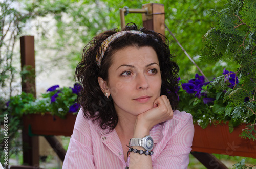 Photo: Pretty thoughtful woman in the garden Pretty thoughtful woman in the garden