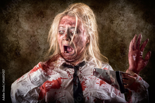 Photo: Dead female zombie with saw and amputated hand Dead female zombie with saw and amputated hand