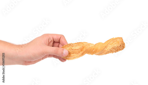 Photo: Hand holds of puff pastry stick Hand holds of puff pastry stick