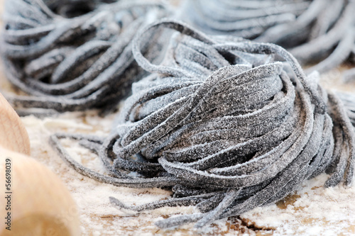 Photo: Homemade fresh black squid ink tagliolini pasta nests Homemade fresh black squid ink tagliolini pasta nests