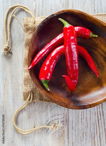 Photo: Chili pepper on wooden table Chili pepper on wooden table