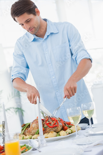 Photo: Attractive man carving the dinner Attractive man carving the dinner