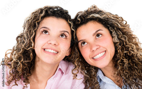 Photo: Thoughtful twins smiling Thoughtful twins smiling