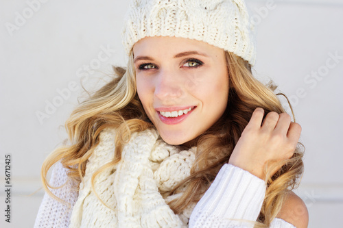 Photo: Portrait of young beautiful woman wearing sweater and hat Portrait of young beautiful woman wearing sweater and hat