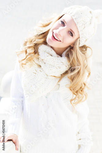 Photo: Portrait of young beautiful woman wearing sweater and hat Portrait of young beautiful woman wearing sweater and hat