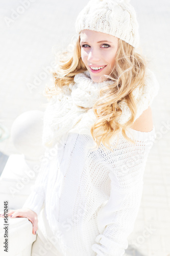 Photo: Portrait of young beautiful woman wearing sweater and hat Portrait of young beautiful woman wearing sweater and hat