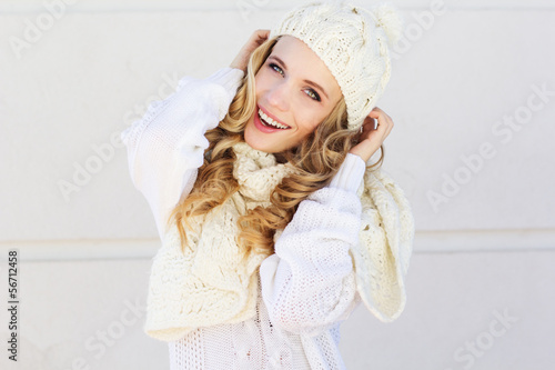 Photo: Portrait of young beautiful woman wearing sweater and hat Portrait of young beautiful woman wearing sweater and hat