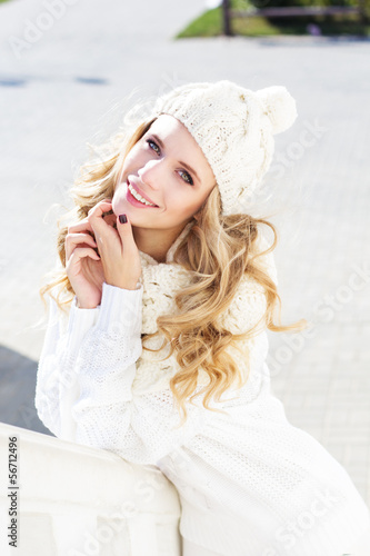 Photo: Portrait of young beautiful woman wearing sweater and hat Portrait of young beautiful woman wearing sweater and hat