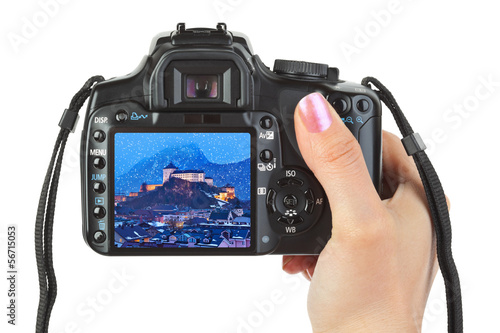 Photo: Camera in hand and winter Austria view Camera in hand and winter Austria view