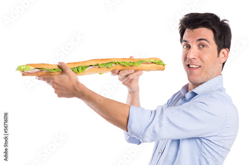 Photo: Happy Man Holding Long Baguette Sandwich Happy Man Holding Long Baguette Sandwich