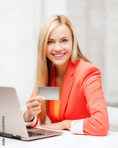 Photo: businesswoman with laptop using credit card businesswoman with laptop using credit card