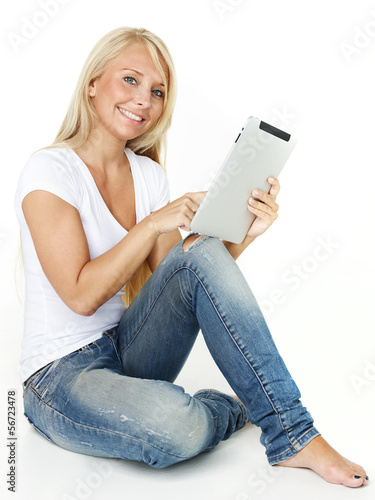 Photo: Woman working on tablet pc Woman working on tablet pc