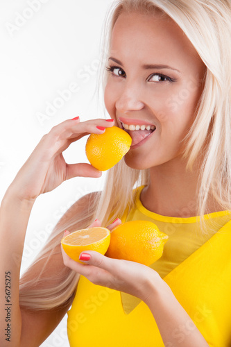 Photo: Portrait of a beautiful woman with lemon fruit Portrait of a beautiful woman with lemon fruit