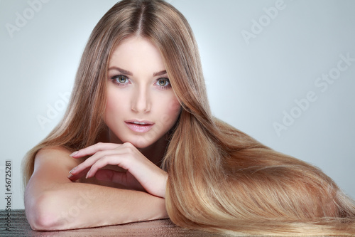 Photo: Beautiful girl, isolated on a light - grey, emotions, cosmetics Beautiful girl, isolated on a light - grey, emotions, cosmetics