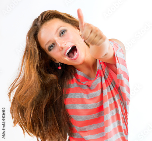 Photo: Happy Teen Girl showing Thumbs up isolated one white Happy Teen Girl showing Thumbs up isolated one white