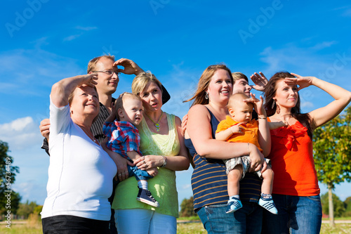 Photo: Family and multi-generation - fun on meadow in summer Family and multi-generation - fun on meadow in summer