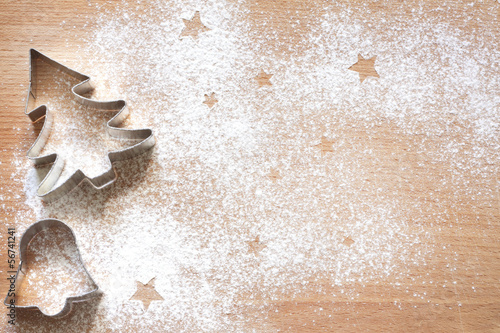Photo: Abstract Christmas food background with cookies molds and flour Abstract Christmas food background with cookies molds and flour