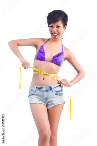 Photo: Woman in bikini in diet concept isolated on white Woman in bikini in diet concept isolated on white