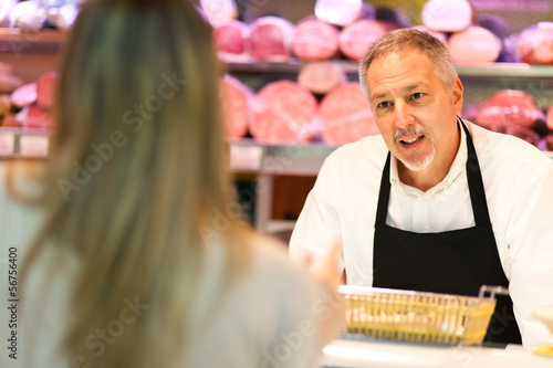 Photo: Shopkeeper serving a customer in a grocery store Shopkeeper serving a customer in a grocery store