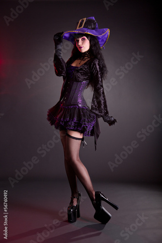 Photo: Pretty witch in purple and black gothic Halloween costume Pretty witch in purple and black gothic Halloween costume