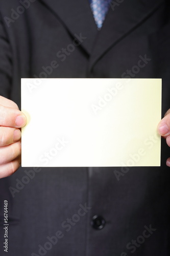 Photo: Close up of business note card in male hand Close up of business note card in male hand