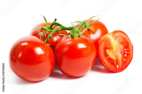 Photo: Closeup of tomatoes on the vine isolated on white. Tomato branch Closeup of tomatoes on the vine isolated on white. Tomato branch
