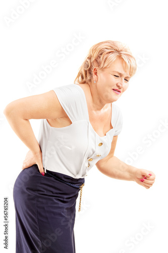 Photo: Mature blond female suffering from a back pain Mature blond female suffering from a back pain