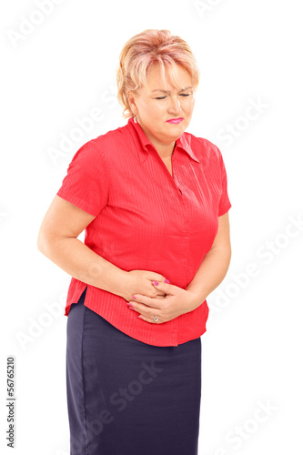 Photo: Mature blond female suffering from a stomach ache Mature blond female suffering from a stomach ache