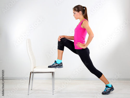 Photo: Beautiful young girl doing exercises at home Beautiful young girl doing exercises at home