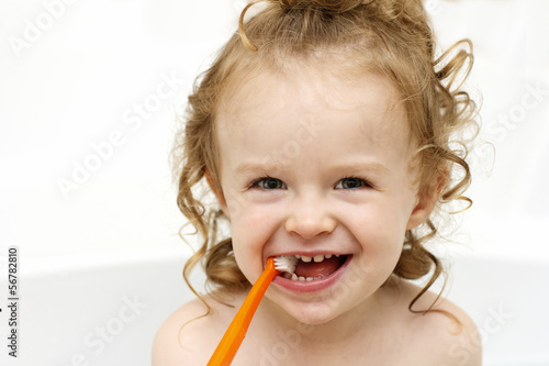 Photo: Little toddler brushing teeth in the bath Little toddler brushing teeth in the bath
