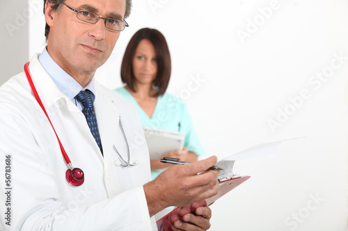 Photo: doctor consulting report doctor consulting report