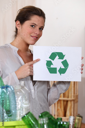 Photo: Woman recycling glass and plastic bottles Woman recycling glass and plastic bottles