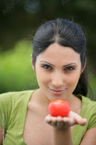 Photo: woman holding a tomato woman holding a tomato