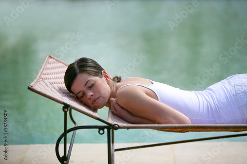 Photo: Woman asleep by a pool Woman asleep by a pool