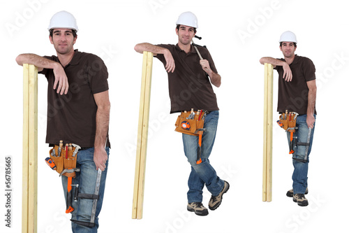 Photo: Carpenter posing with a plank of wood Carpenter posing with a plank of wood