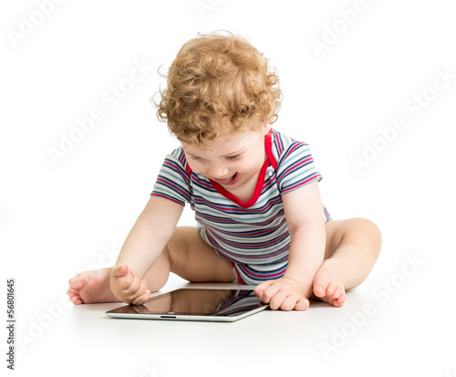 Photo: baby boy playing with digital tablet isolated on white baby boy playing with digital tablet isolated on white