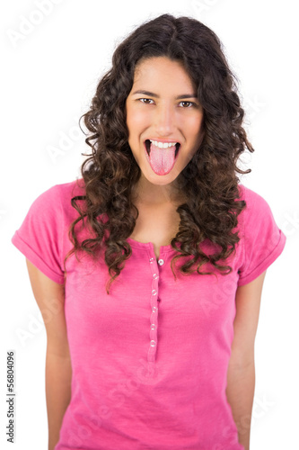 Photo: Disgusted long haired brunette sticking her tongue out Disgusted long haired brunette sticking her tongue out