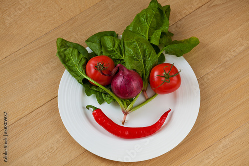Photo: Vegetable face on a white plate Vegetable face on a white plate