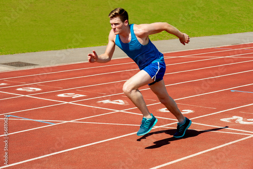 Photo: Male runner on starting blocks Male runner on starting blocks